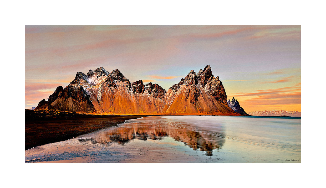 Serene Iceland coast with mirror-like reflection of jagged mountains