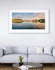 Gentle clouds and islands reflected in glassy water surface