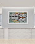 Framed artwork on a wall in an office setting with silos