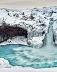 Winter waterfall in Iceland with basalt columns