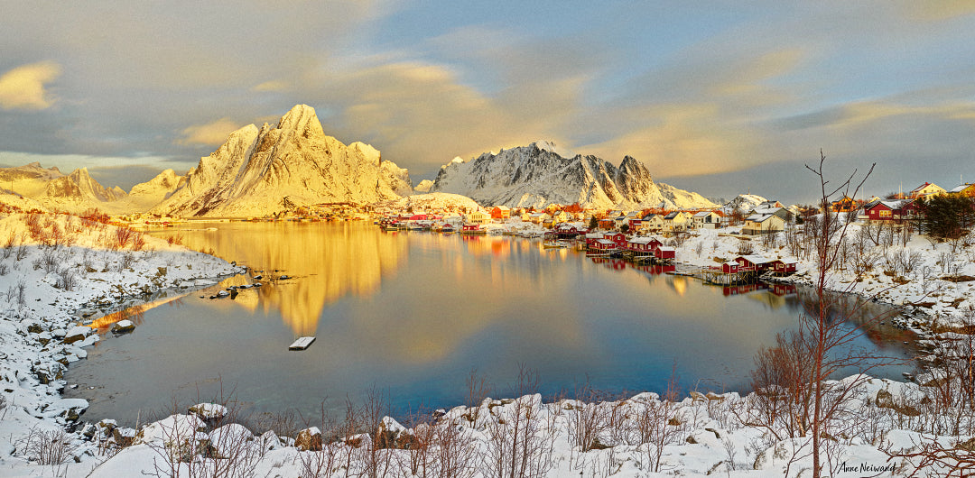 Golden hour photograph of snowy village in Lofoten Islands, Norway