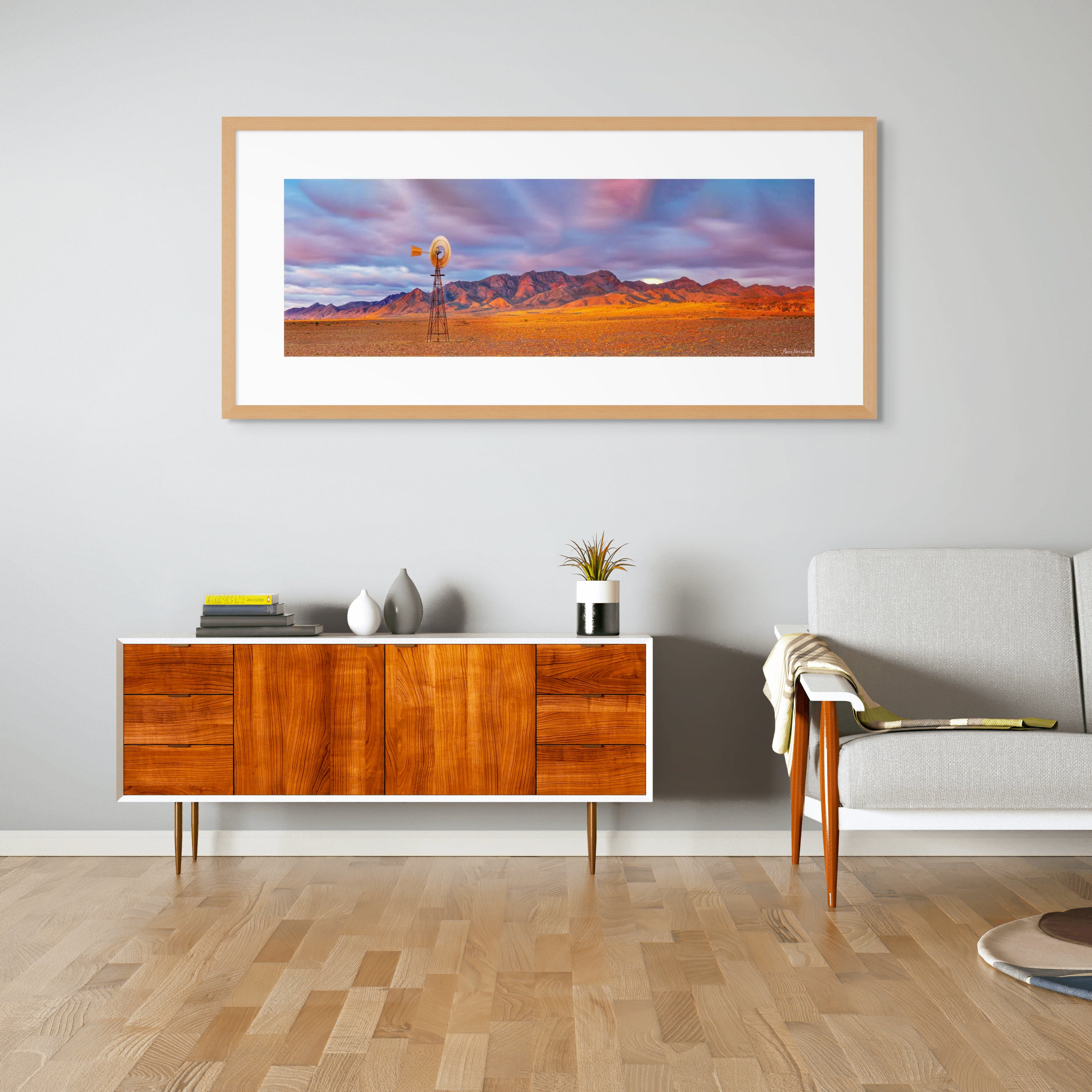 Outback landscape with stormy sky and weathered windmill in golden light