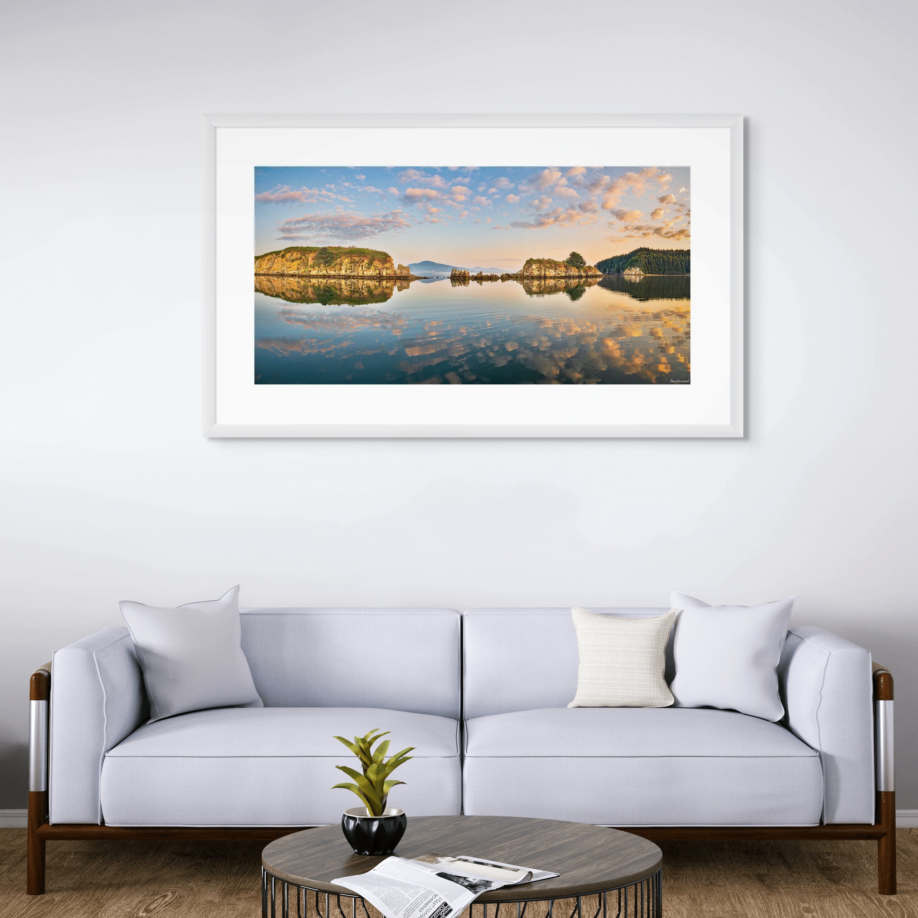Gentle clouds and islands reflected in glassy water surface