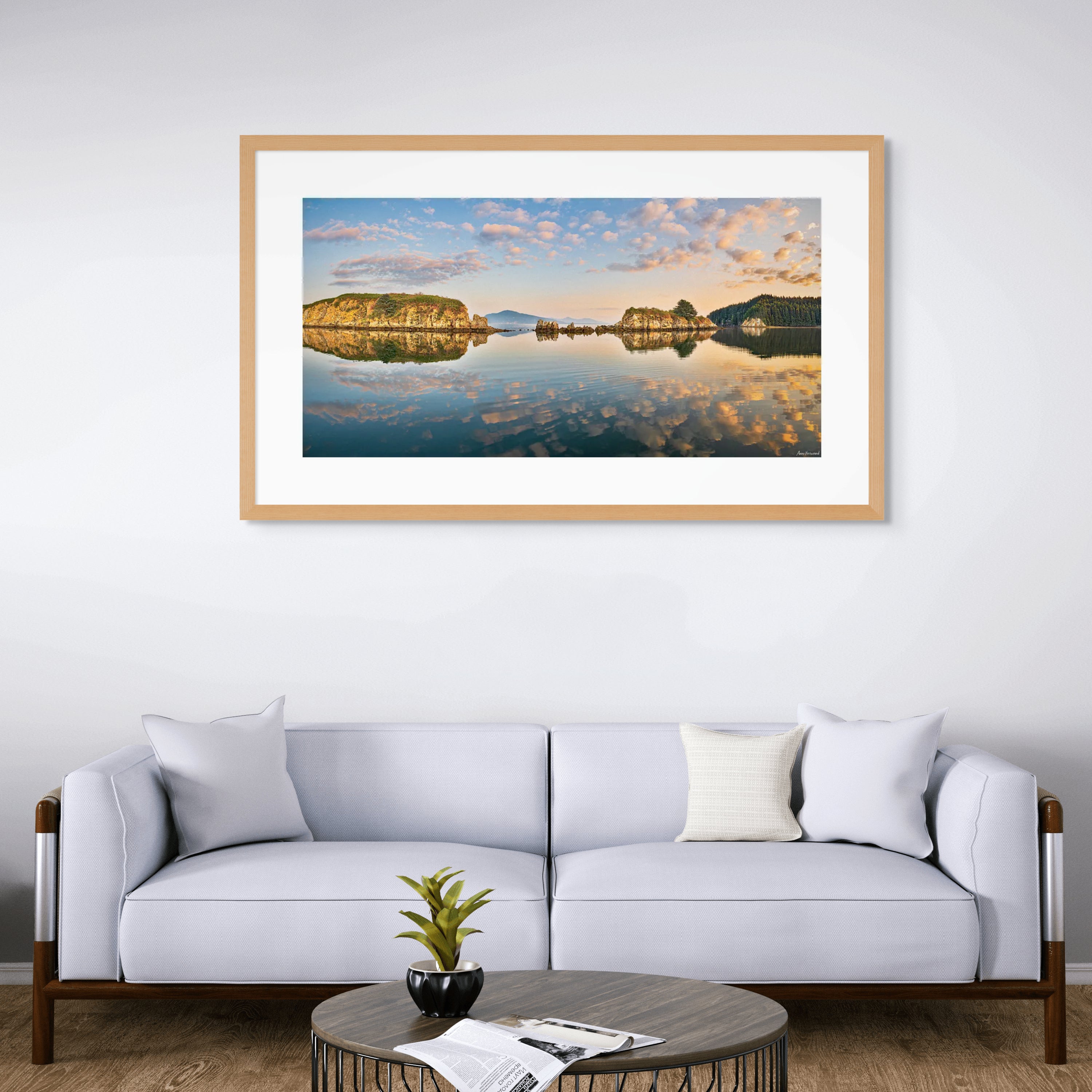 Golden hour photo of still bay and rocky islets in Alaska