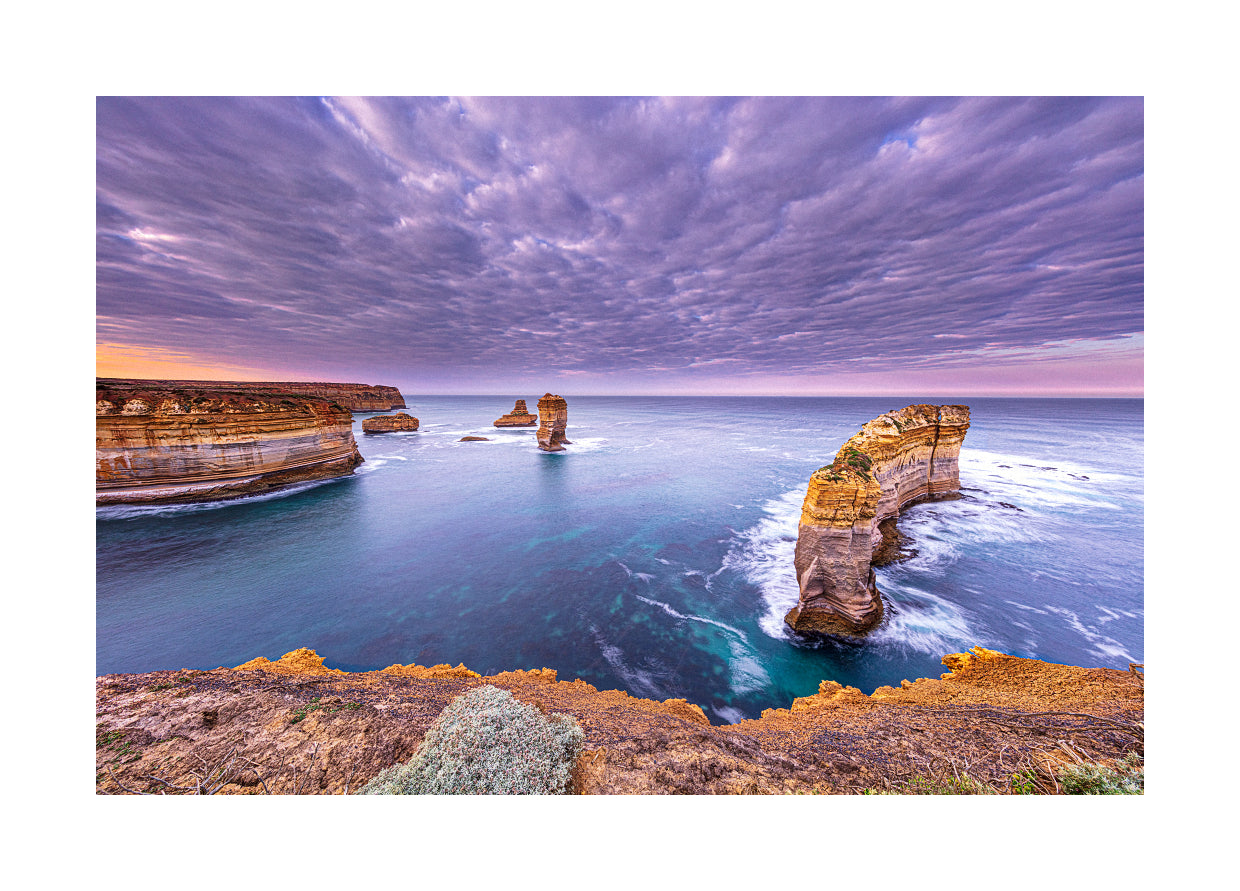 Southern Ocean landscape featuring towering sea stacks and calm tide